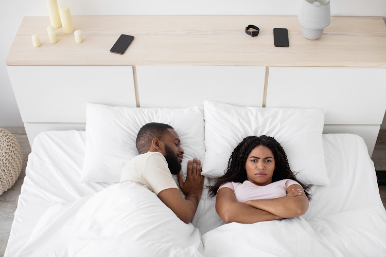 A man and a woman sleeping in bed, she is angry. A man and a woman sleeping in bed, she is angry.