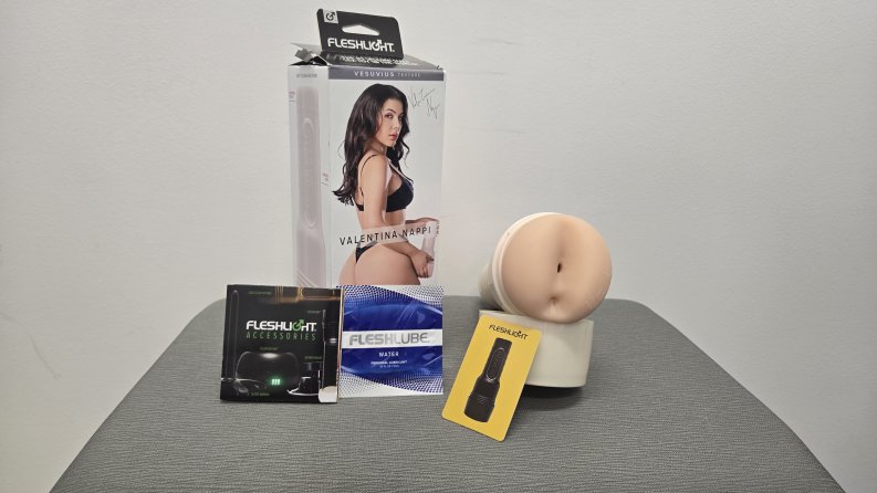 The Fleshlight with lube, a pamphlet, and a rewards card.