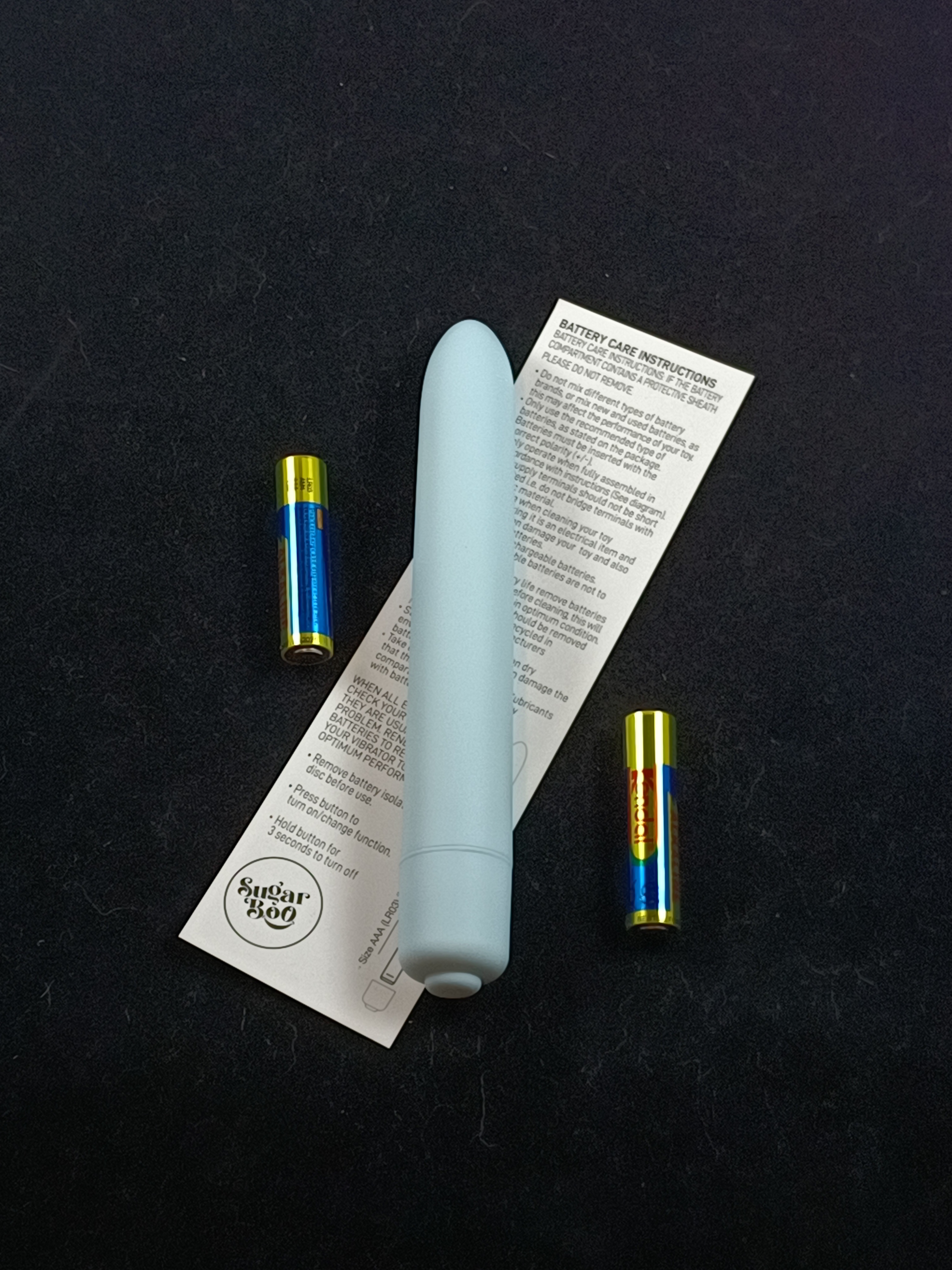 Pictured is the Rocks-Off SugarBoo Bullet with care instructions and batteries. Pictured is the Rocks-Off SugarBoo Bullet with care instructions and batteries.