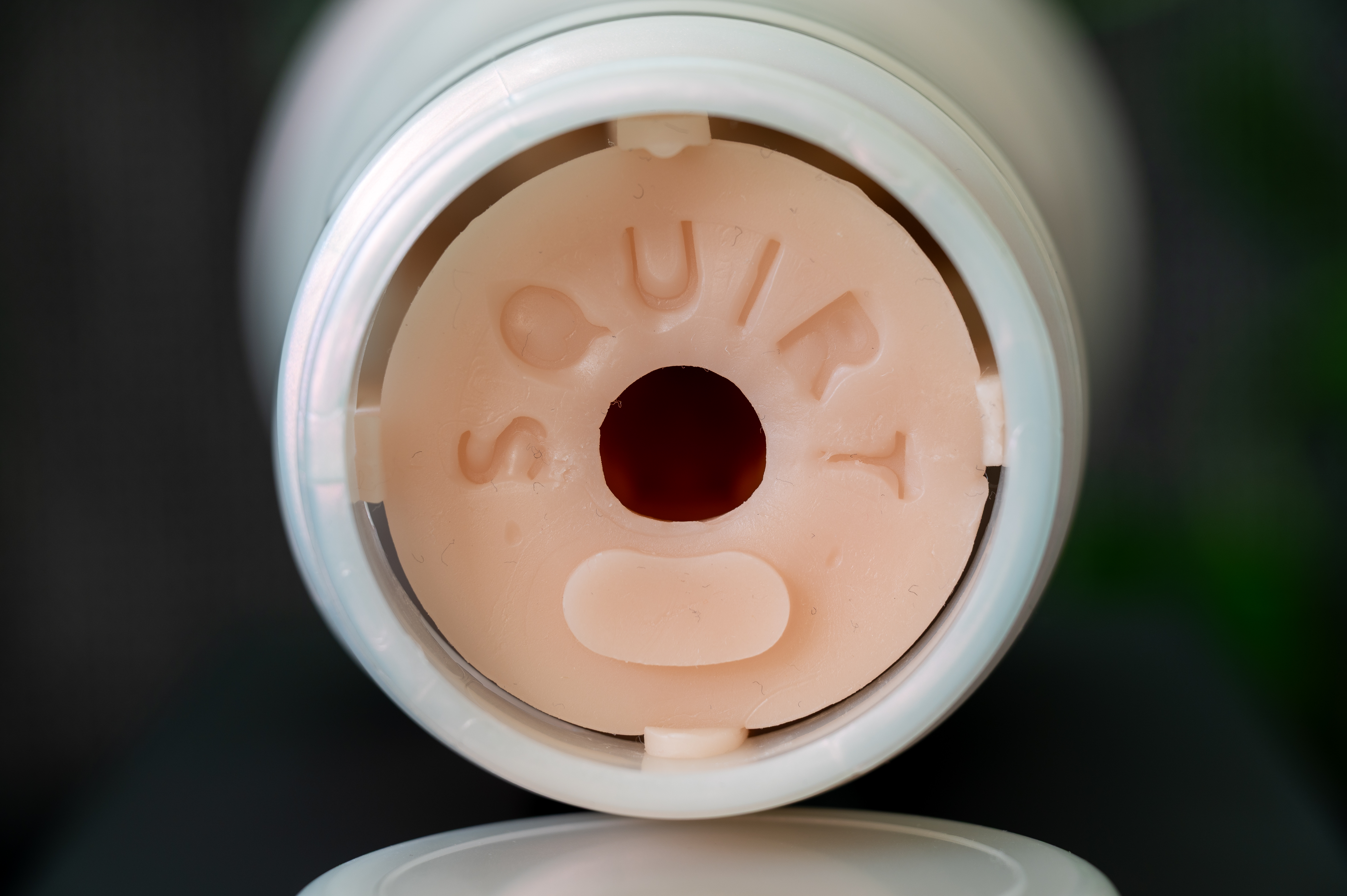 The backside of the Fleshlight Emily Willis Squirt toy with squirt written on the skin.