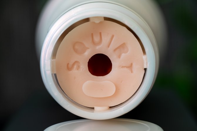The backside of the Fleshlight Emily Willis Squirt toy with squirt written on the skin.