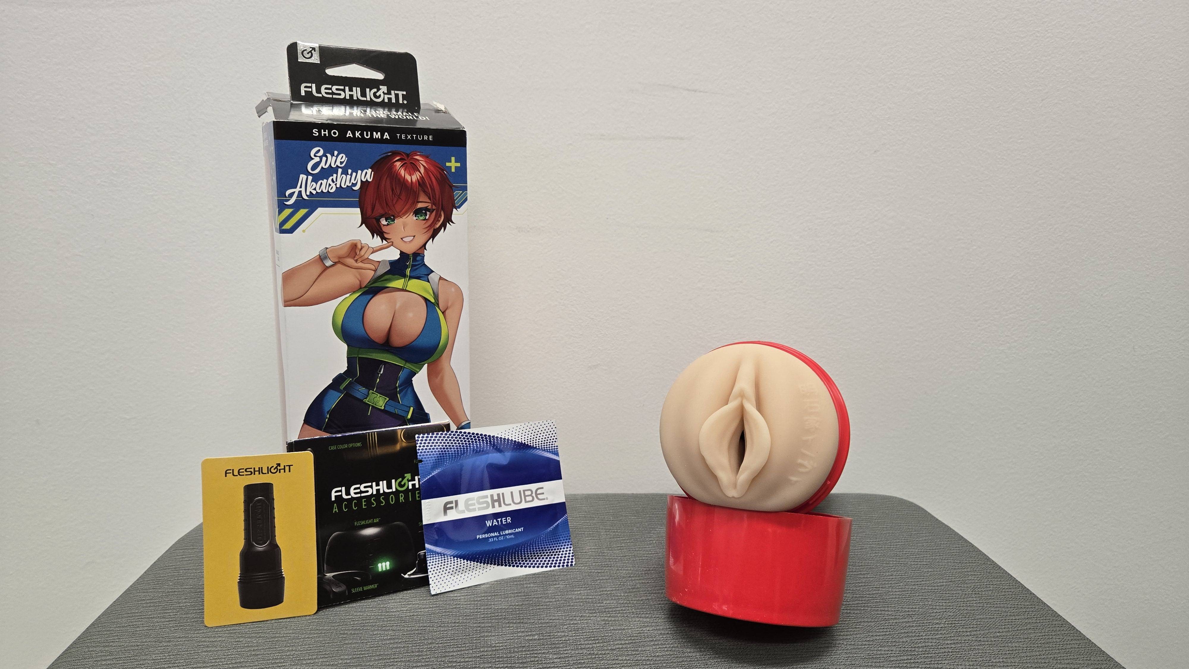 The Evie Akashiya Fleshlight box with lube, a rewards card, and a pamphlet. The Evie Akashiya Fleshlight box with lube, a rewards card, and a pamphlet.