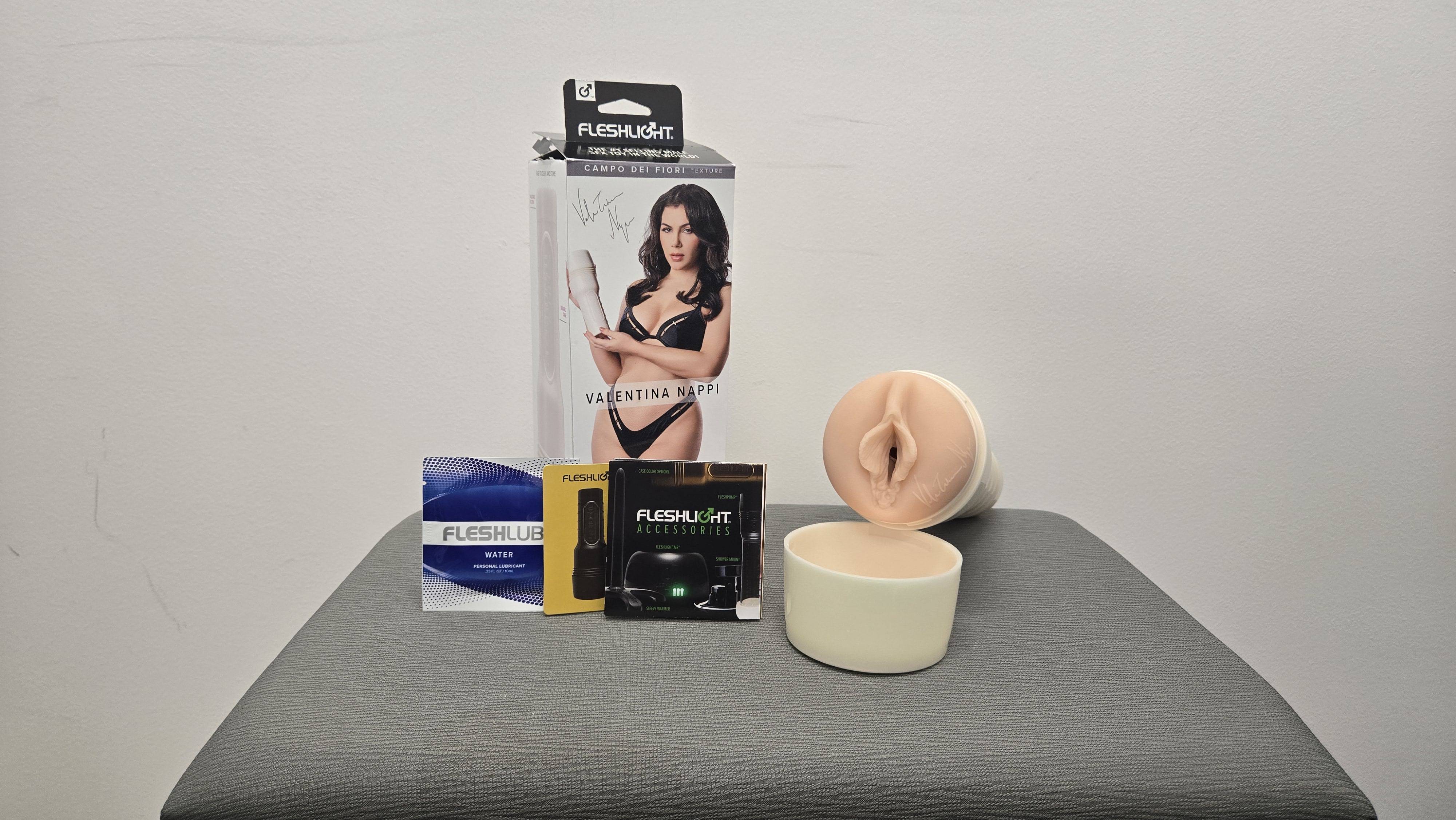 The Valentina Nappi Fleshlight can be seen with the included lube, rewards card, and pamphlet. The Valentina Nappi Fleshlight can be seen with the included lube, rewards card, and pamphlet.
