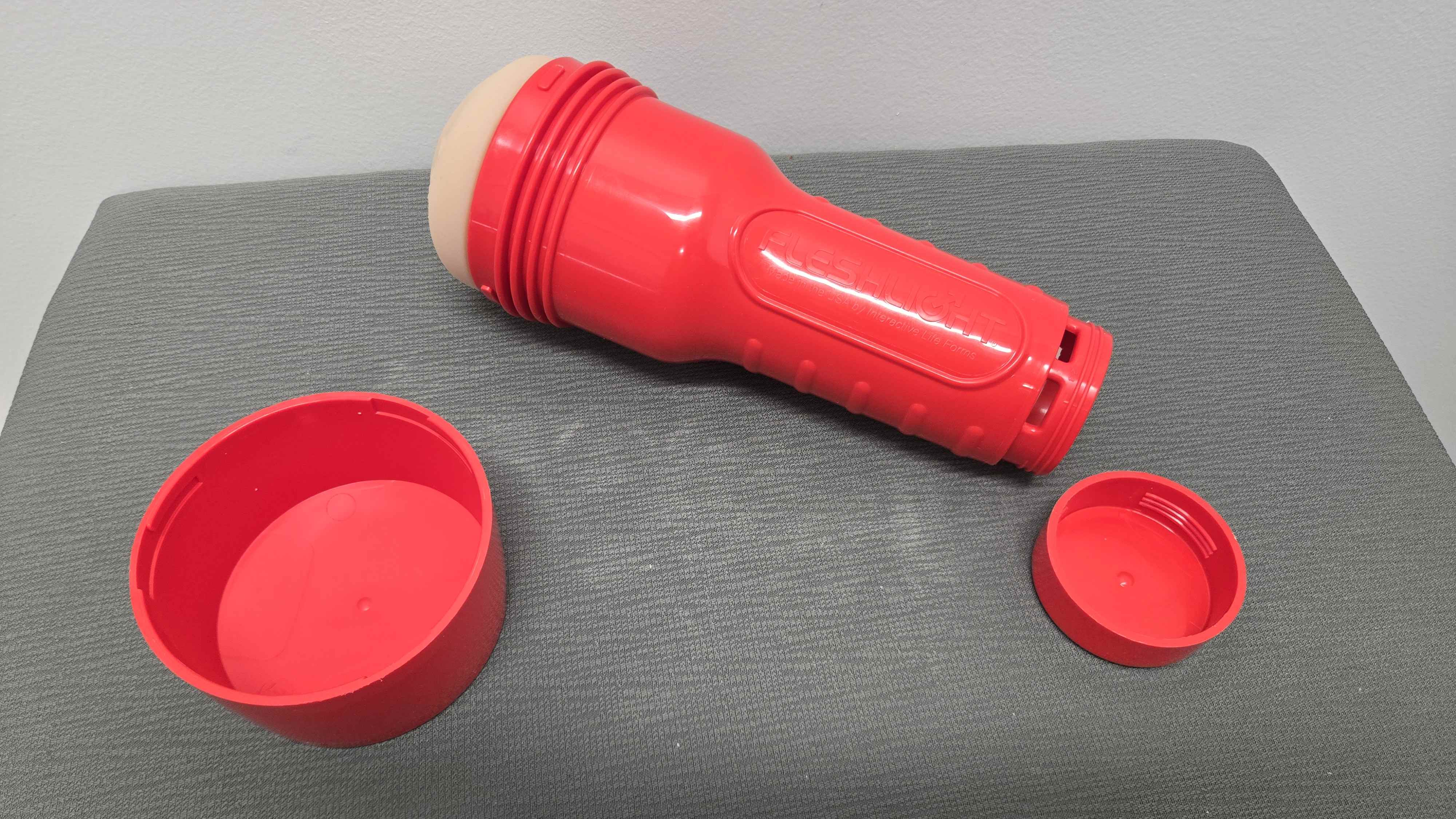 The Evie Akashiya Fleshlight toy laying down with the caps taken off. The Evie Akashiya Fleshlight toy laying down with the caps taken off.