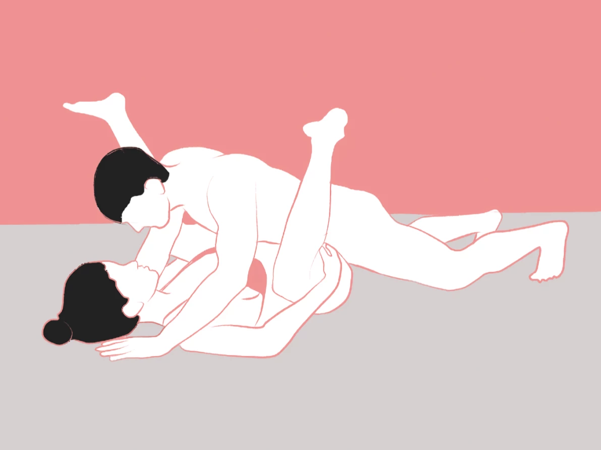 A couple having missionary sex with a sex toy.