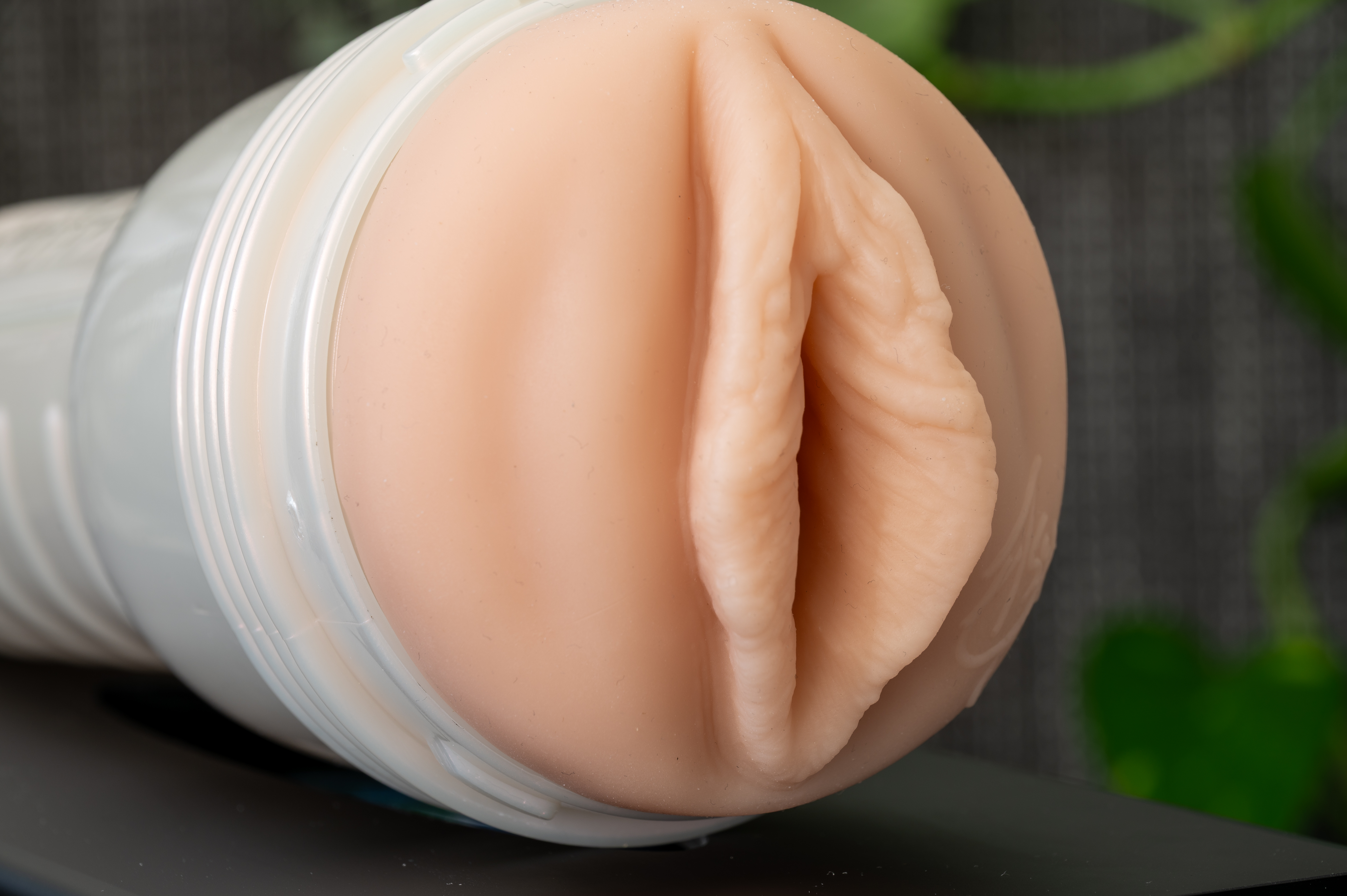 The Fleshlight is pictured here from a side angle, in a tan color with pronounced lips and hood. The Fleshlight is pictured here from a side angle, in a tan color with pronounced lips and hood.