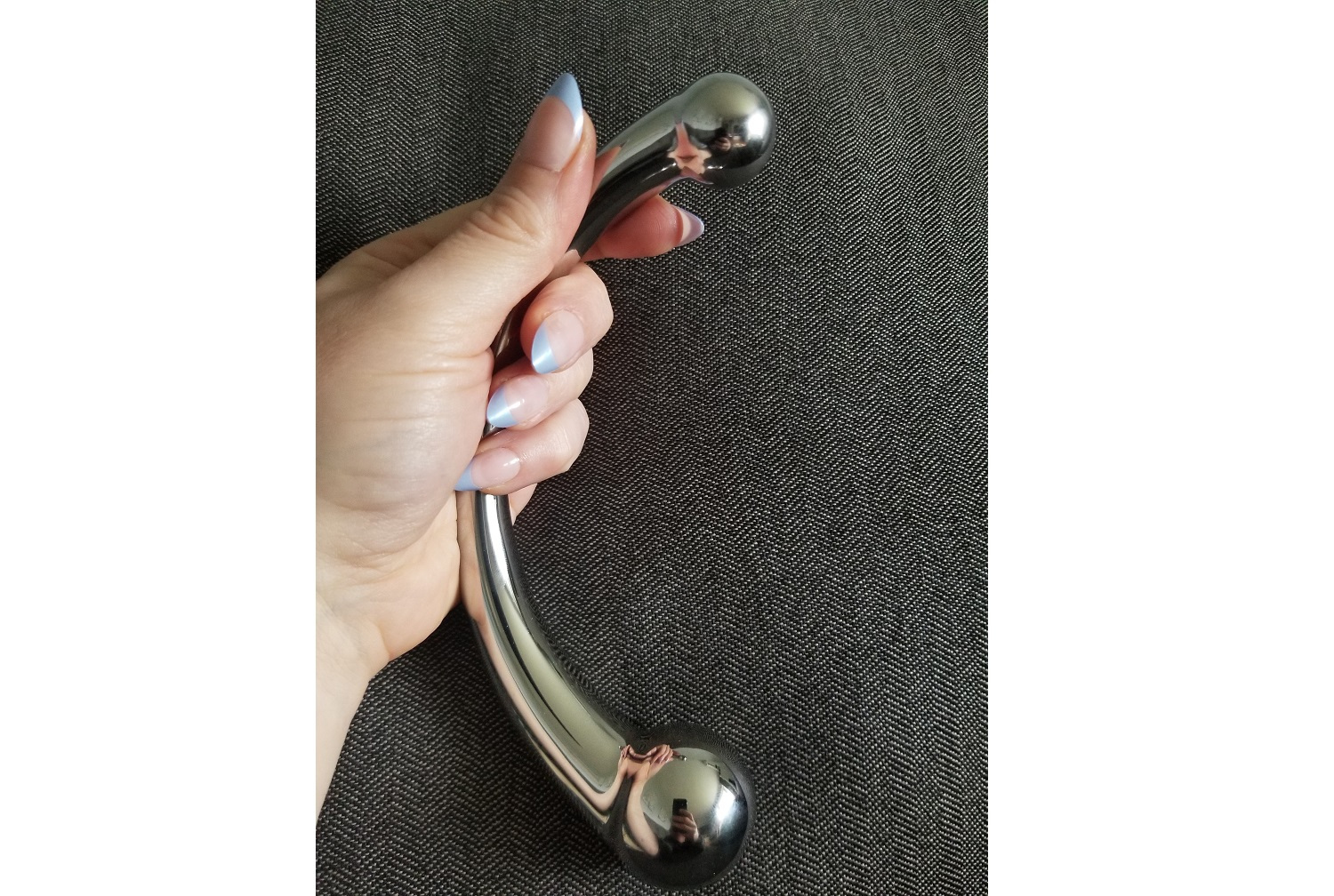 The Pure Wand from a frontal angle showcasing the barbell curve of the toy. The Pure Wand from a frontal angle showcasing the barbell curve of the toy.