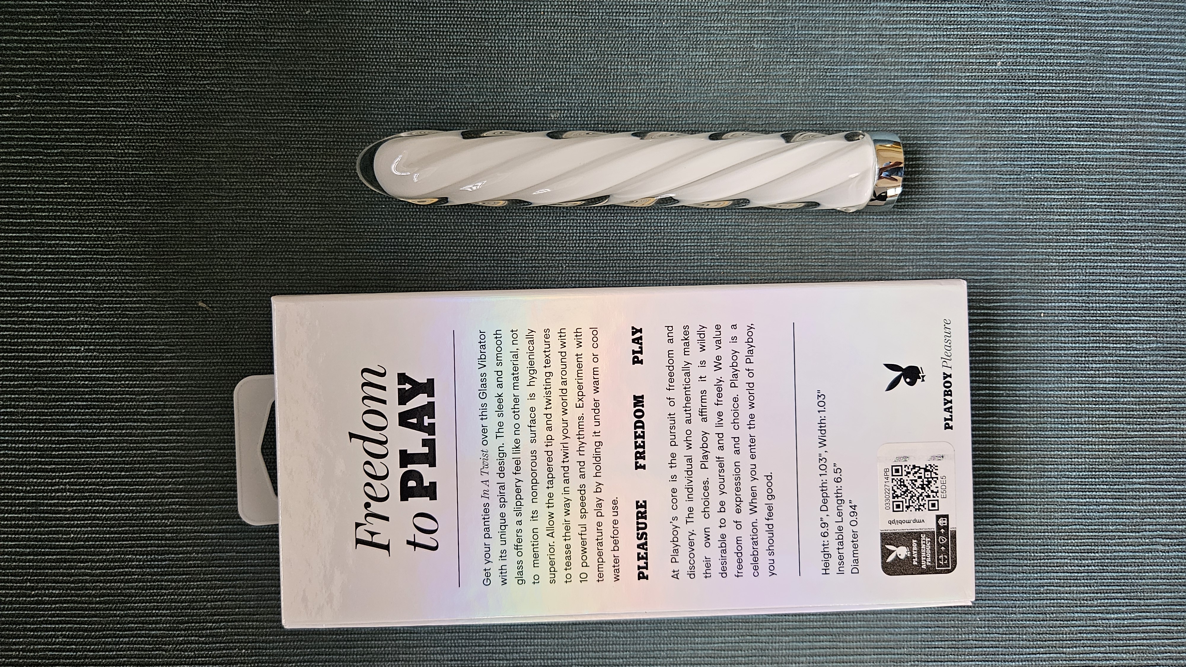 Playboy Pleasure In A Twist Glass Vibrator with a box description of the Playboy brand.